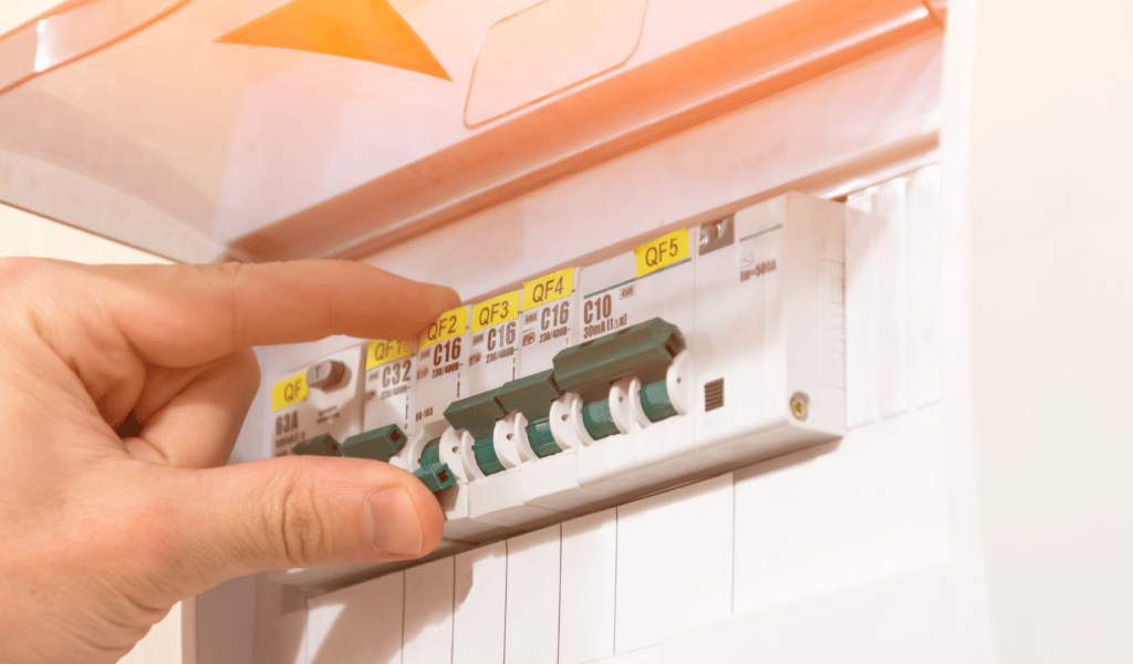 A hand flicking switch of fuse board